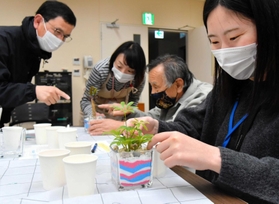 カラフルな砂をガラス容器に注いで模様を描く参加者=淡路県民局 カラフルな砂をガラス容器に注いで模様を描く参加者=淡路県民局