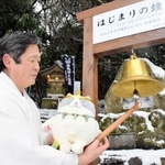 境内に設置した「はじまりの鐘」を鳴らす奥本憲治宮司と主人公「マル」のぬいぐるみ=諭鶴羽神社