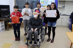 車いすを寄贈した竹谷小の児童と、利用者の男性=トラストシップ尼崎 車いすを寄贈した竹谷小の児童と、利用者の男性=トラストシップ尼崎