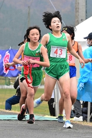 女子・香寺の2区梶原つかさ選手(右)からたすきを受け取り、走りだす3区辻莉愛選手=豊岡市日高町(撮影・秋山亮太) 女子・香寺の2区梶原つかさ選手(右)からたすきを受け取り、走りだす3区辻莉愛選手=豊岡市日高町(撮影・秋山亮太)