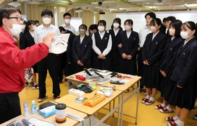 防災士の久保功さん(左)から防災用品の説明を受ける姫路商業高校の生徒ら=姫路市井ノ口 防災士の久保功さん(左)から防災用品の説明を受ける姫路商業高校の生徒ら=姫路市井ノ口