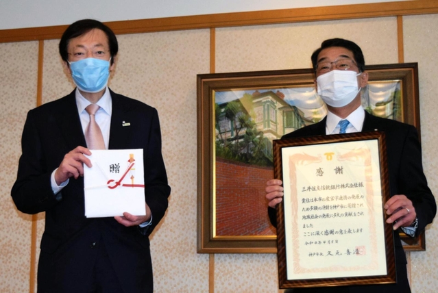 目録を受け取った久元喜造市長(左)と感謝状を手にする田中尚宏専務執行役員=神戸市役所