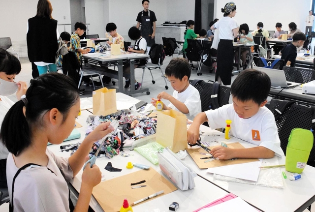 布の端切れで工作に取り組む参加者たち=神戸市中央区港島中町6、ワールド