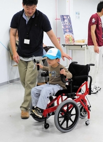 足こぎ式車いす「コギー」に試乗する子ども(製造販売元のTESS提供) 足こぎ式車いす「コギー」に試乗する子ども(製造販売元のTESS提供)