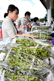 店頭に積まれた黒枝豆を買い求める人々=丹波篠山市東吹、味土里館 店頭に積まれた黒枝豆を買い求める人々=丹波篠山市東吹、味土里館
