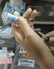 ヘパリンを注射器で吸い取り、生理食塩水に混ぜて点滴薬にする=西宮市武庫川町(撮影・神子素慎一) ヘパリンを注射器で吸い取り、生理食塩水に混ぜて点滴薬にする=西宮市武庫川町(撮影・神子素慎一)