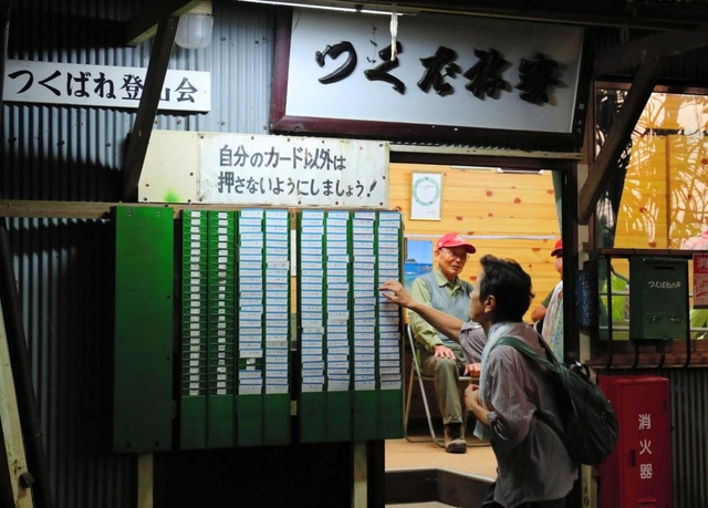 夜明け前。つくばね寮に掛けられたタイムカードを手に取る人たち=神戸市灘区岩屋(撮影・大山伸一郎) 夜明け前。つくばね寮に掛けられたタイムカードを手に取る人たち=神戸市灘区岩屋(撮影・大山伸一郎)