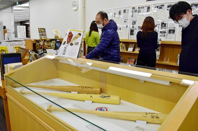 歴代の名選手の野球道具などが並ぶ企画展＝県立図書館