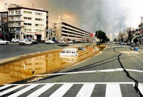 道路が陥没し、水没した交差点。周囲で渋滞が発生し、警察の現場作業などに影響が出た＝１９９５年１月、神戸市兵庫区大開通