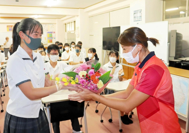 生徒代表から花束を贈られる新沢由貴選手（右）＝明石市二見町西二見