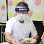 利用者の食事の介助をする興津さん＝明石市大久保町大窪