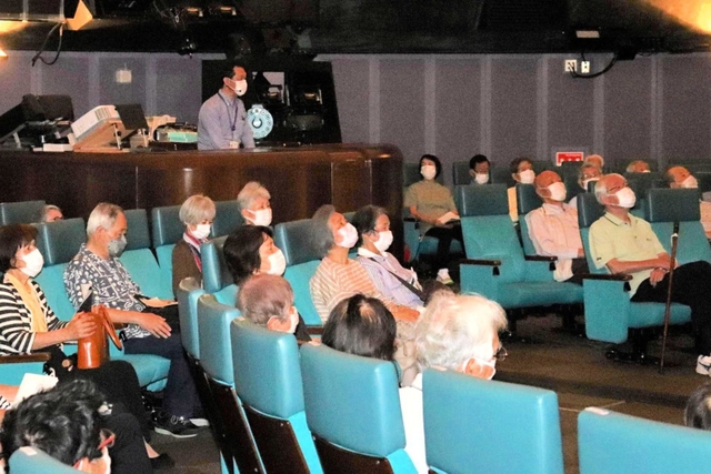 井上毅館長の解説に聞き入る参加者＝明石市人丸町