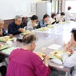 和気あいあいと給食を楽しむ参加者たち＝魚住コミュニティ・センター