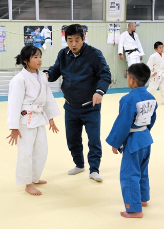 子どもたちに指導する斉藤裕史監督＝明石市二見町