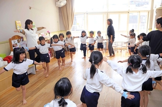 「プテラノドン」のポーズに取り組む子どもたち＝明石市宮の上