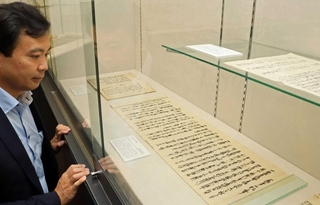 新たに見つかった林崎掘割関連の文書を見る中村健史准教授＝神戸市中央区港島１