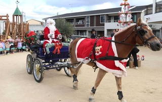 馬車に乗ったサンタクロースと見守る園児ら＝明石市大久保町大久保町