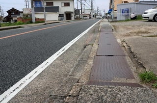 山陽電鉄中八木駅東側にある県道明石高砂線の歩道。狭く段差が目立つ＝明石市大久保町谷八木