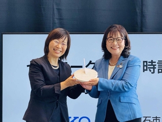 クラゲ日時計の模型を手に持つセイコーグループの金川宏美常務執行役員（左）と丸谷聡子市長＝あかし市民広場