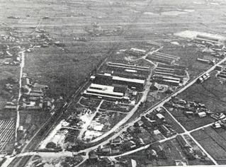 終戦直後に撮影された東亜金属工業土山工場（現ＴＯＹＯイノベックス）の空撮。手前に白く見える空き地が空襲の跡だ（東洋機械金属六十年史より引用）