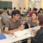 少人数のグループに分かれ、支援者から熱心に日本語を学ぶ生徒ら＝明石市西明石南町１