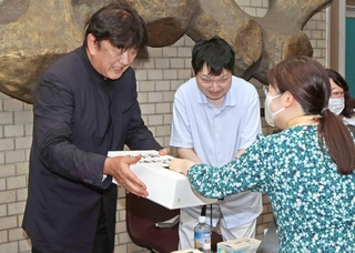 来場者に募金への協力を呼びかける佐渡裕さん（左）と山本育海さん＝明石市立市民会館