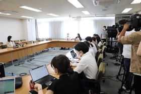 大勢の報道陣の前で、次期尼崎市長選に立候補しない意向を表明した稲村和美氏（左）＝７月７日午前、尼崎市役所