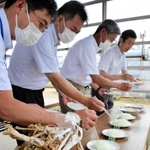 宇宙に行った淡路島産タマネギの栽培収穫報告会で、試食に臨む関係者＝南あわじ市八木養宜中