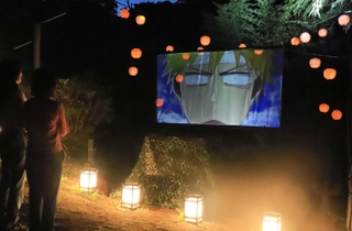 アニメのシーンが投影されたプロジェクションマッピングを見ながら進むナイトウオーク＝淡路市楠本