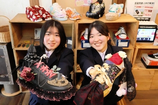 独自の世界観を表現したスニーカーアートを手にする中本旺那さん（左）と中内美優さん＝洲本市本町６