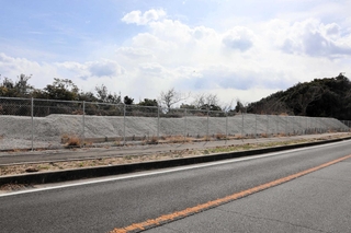 市有地に仮置きされた門崎砲台の射撃口周辺部分。砕石をかけて保存している＝南あわじ市福良丙