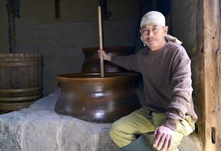 甕仕込みでどぶろくを醸造する長慶寺健太郎さん＝南あわじ市榎列大榎列