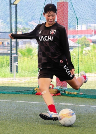 得意のロングパスを練習する小泉恵奈さん＝淡路市生穂新島