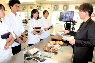 「買いたくなる何かがなければ販売促進につながらない」と、生徒の考えたレシピに助言する小野孝太さん（右）＝淡路市富島、淡路高校