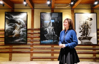 竜や仏を描いた大作を展示する増田薫さん。美しいモノクロームの世界へいざなう＝洲本市本町７