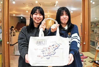 トートバッグを手にする川野心結さん（左）と岩尾凪紗さん＝洲本市本町６