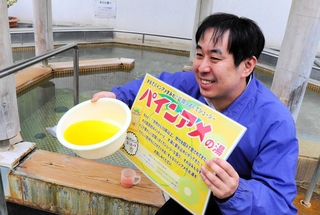 甘酸っぱい香りの「パインアメの湯」をアピールする広報担当者＝淡路市尾崎