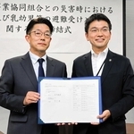 協定書に署名した洲本温泉事業協同組合の木下学代表理事（左）と吉平敏孝市長＝洲本市役所