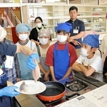 講師の柏木裕子さん（左）にアジのソテーの作り方を教わる５年生＝浦小学校