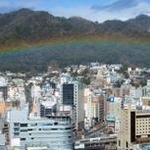 六甲山麓の市街地に低く架かった虹＝４日午前、神戸市役所から（撮影・若林幹夫）