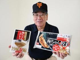 ギョーザやカレーの商品を手に笑顔を見せる梅田茂雄さん＝芦屋市大原町