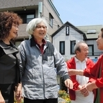 映画「男はつらいよ」シリーズ最終作のロケ地を訪ね、住民らとの再会を喜ぶ山田洋次監督（左から２人目）＝１２日午前、神戸市長田区菅原通４