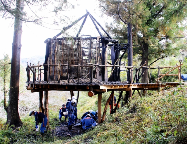 ツリーハウスの焼け跡を現場検証する丹波篠山市消防本部の職員ら＝丹波篠山市遠方