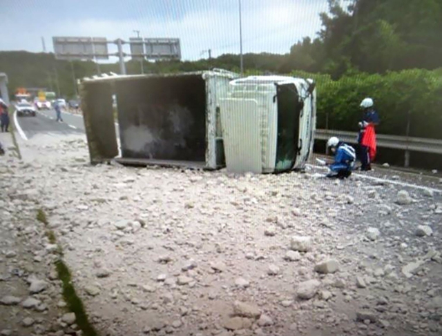 トラックが横転し、荷台からこぼれ出たコンクリート片が道路をふさいだ＝１２日午前、神戸市西区伊川谷町（兵庫県警提供）