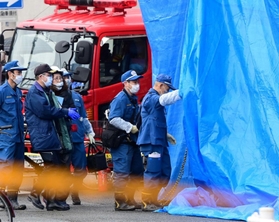 火災があった集合住宅に入る兵庫県警の捜査員ら＝２３日午前、神戸市兵庫区湊町１