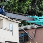 倒れたクレーンの復旧作業にあたる作業員＝１４日午後３時５６分、灘区赤松町１