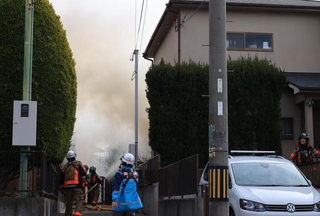 奥まった民家から出火し、煙が立ちこめる現場周辺＝１４日午後０時３０分、西宮市深谷町