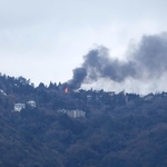 炎と黒煙が見える六甲山上＝１０日午後１時１９分、神戸市中央区東川崎町から