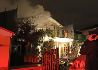 白煙を上げる民家＝１１日午後７時５３分、西宮市新甲陽町