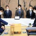 初手を指す徳田拳士四段（左）。右は斉藤優希三段＝１５日午後、加古川市加古川町北在家、鶴林寺